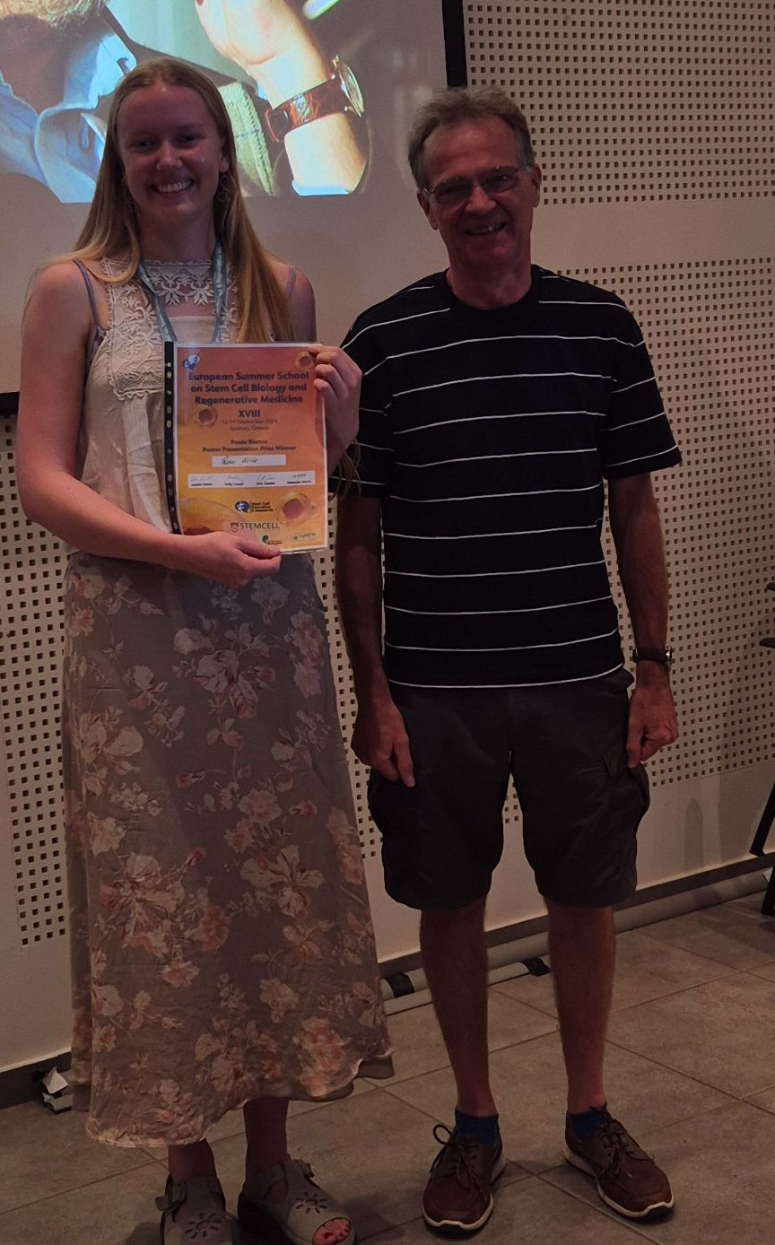 Rosie Willis holding her Paolo Bianco Poster Presentation Prize certificate